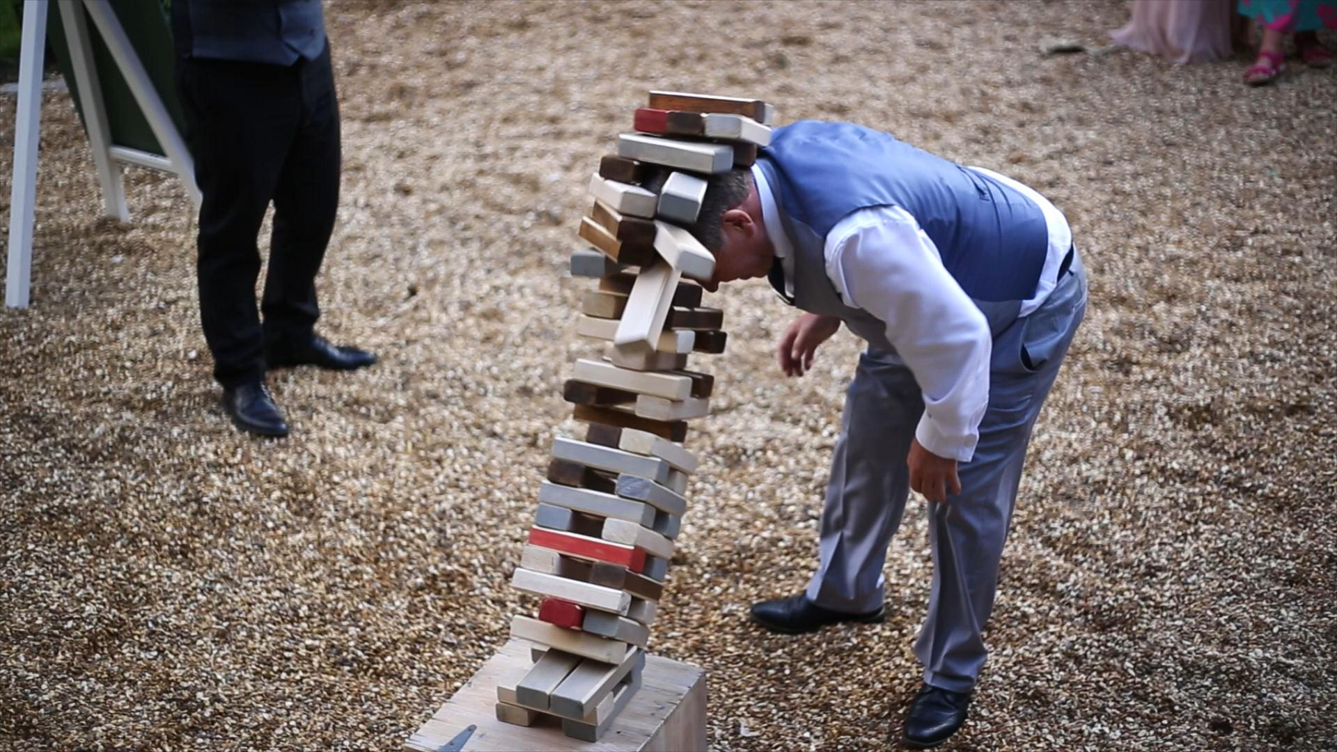 Rebecca and Nathan Ashfield House Wedding 24 giant jenga falls and hits wedding guest on head