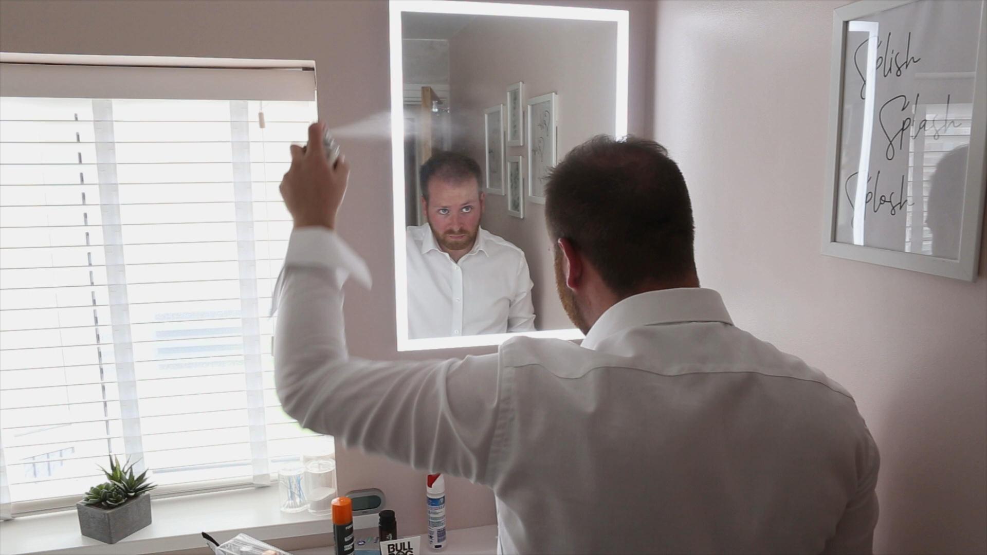 Rebecca and Nathan Ashfield House Wedding 3 groom spraying hair on wedding morning