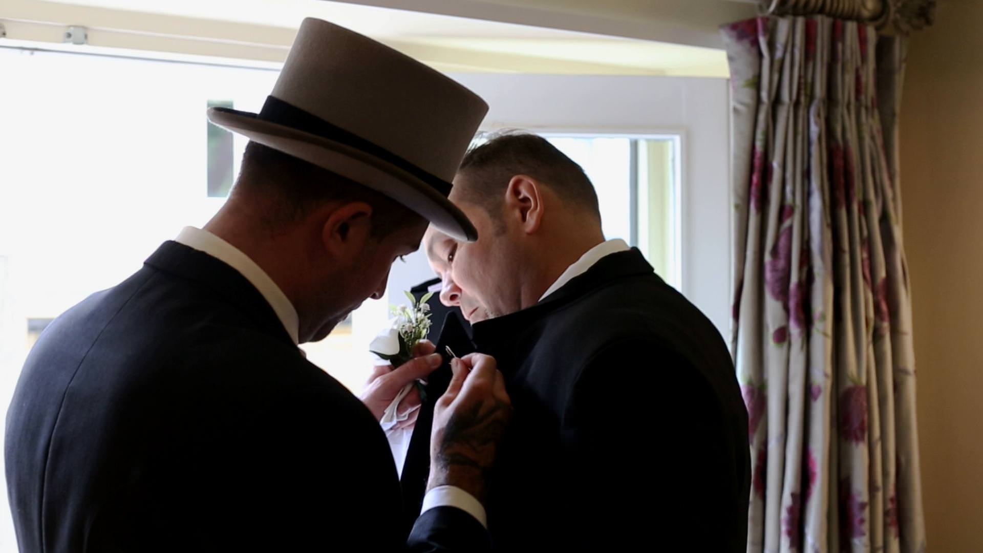 groom wipes his forehead during wedding morning
