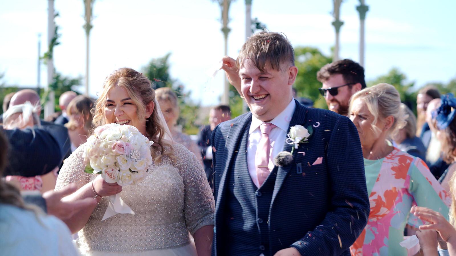bride and groom get covered in confetti in liverpool