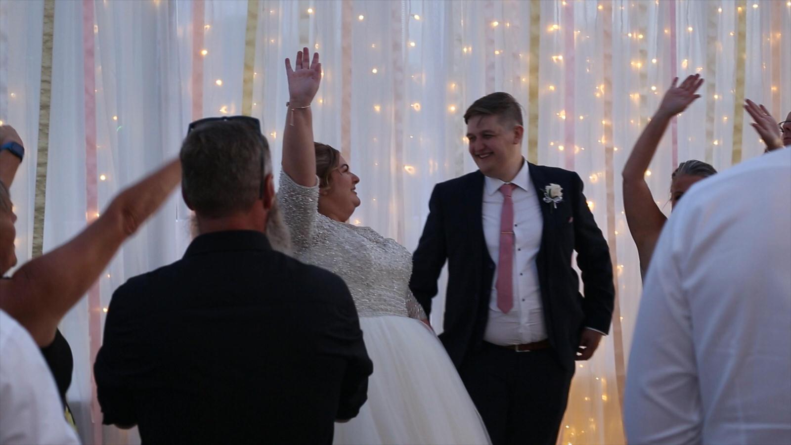 vide still of everyone cheering for couple after first dance