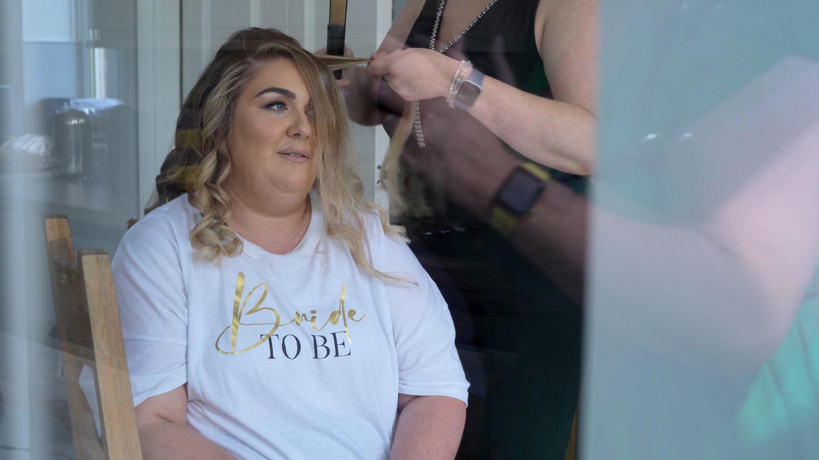 video still of bride getting her hair done