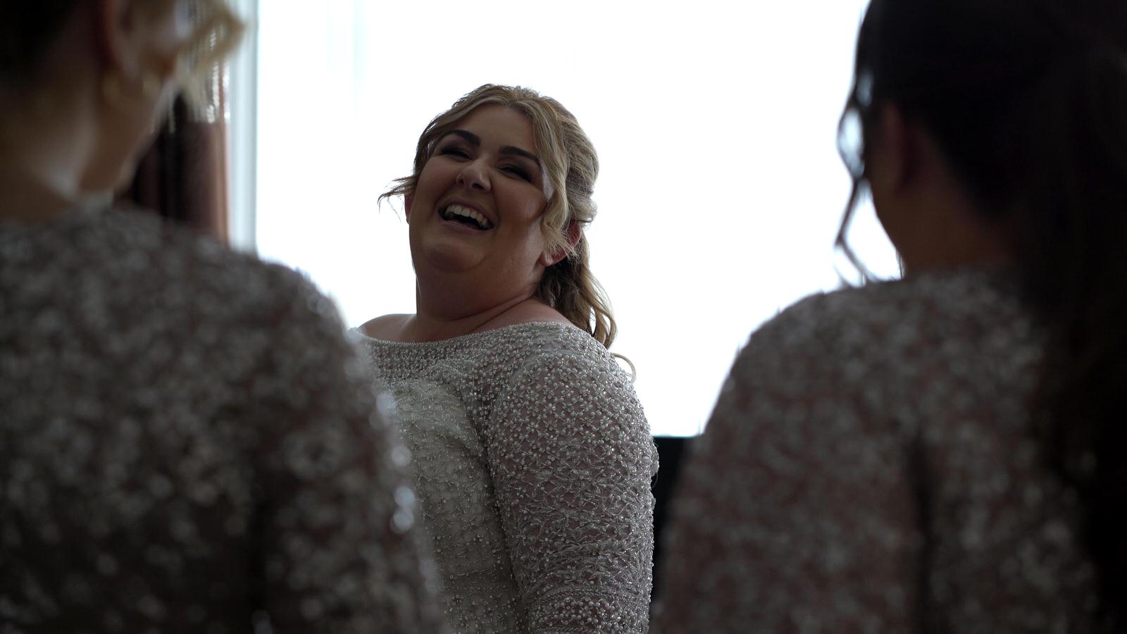video still bride laughs at her bridesmaids
