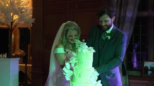 couple cut wedding cake at inglewood manor