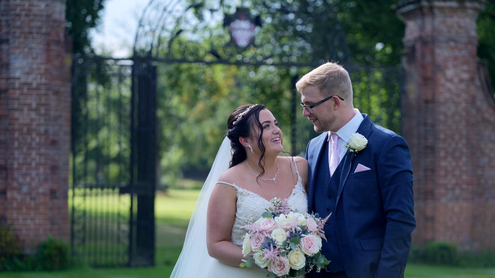 couple smile at each other in Inglewood Manor gardens