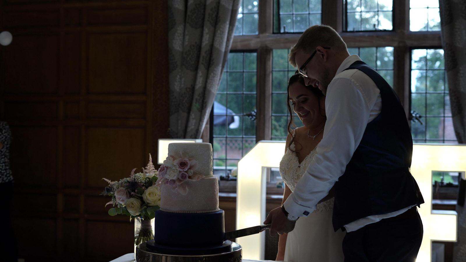 couple cut wedding cake at Inglewood Manor