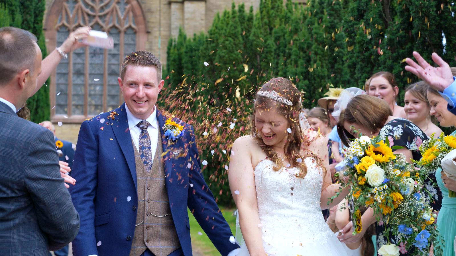 bride and groom showered in natural confetti