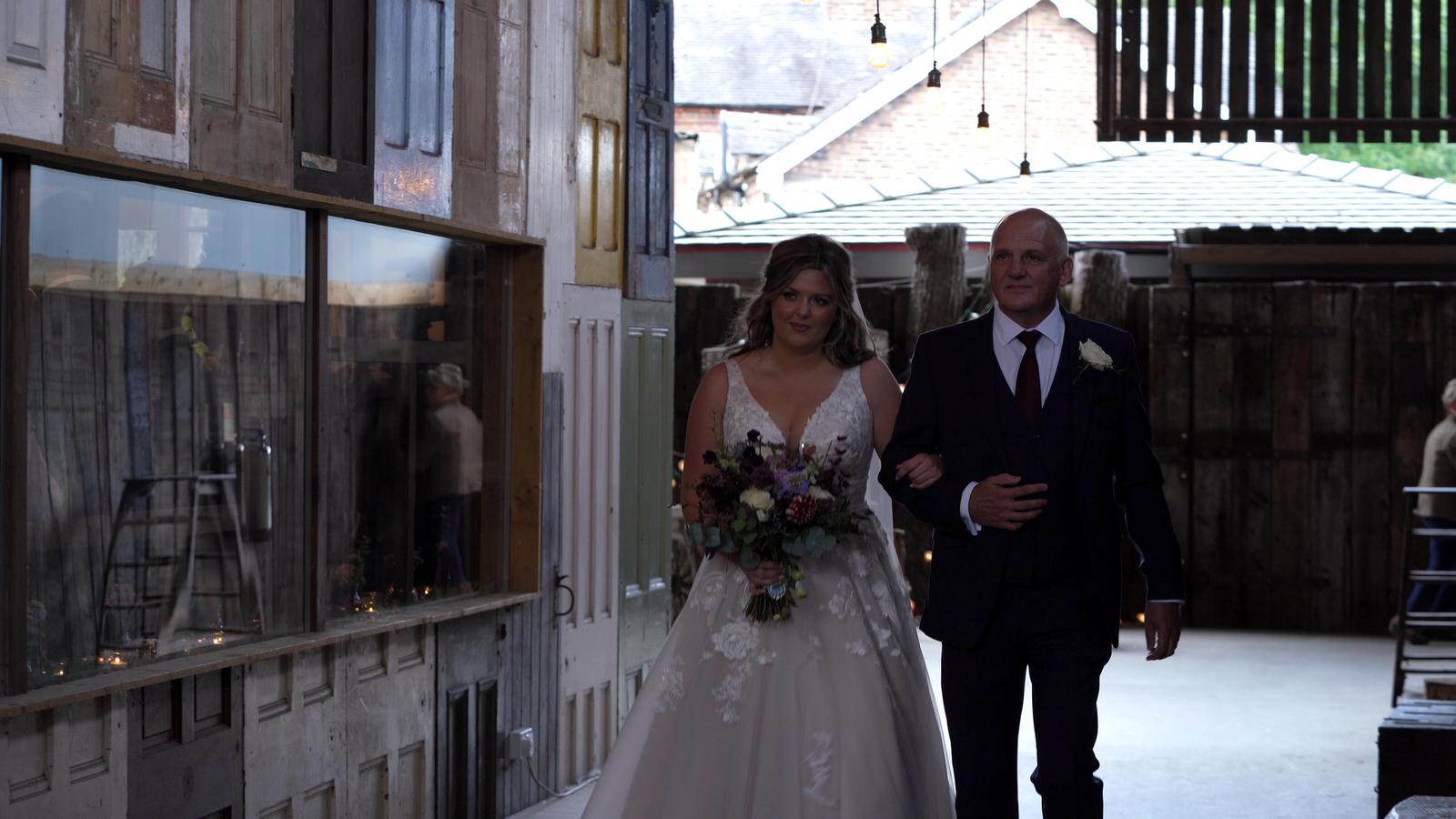 dad and bride walk down the aisle at Owen House Barn