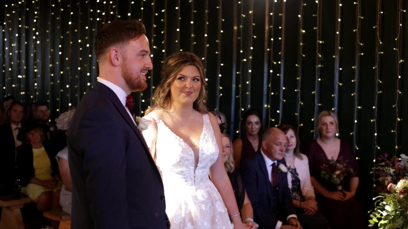 videographer films brides loving look during ceremony