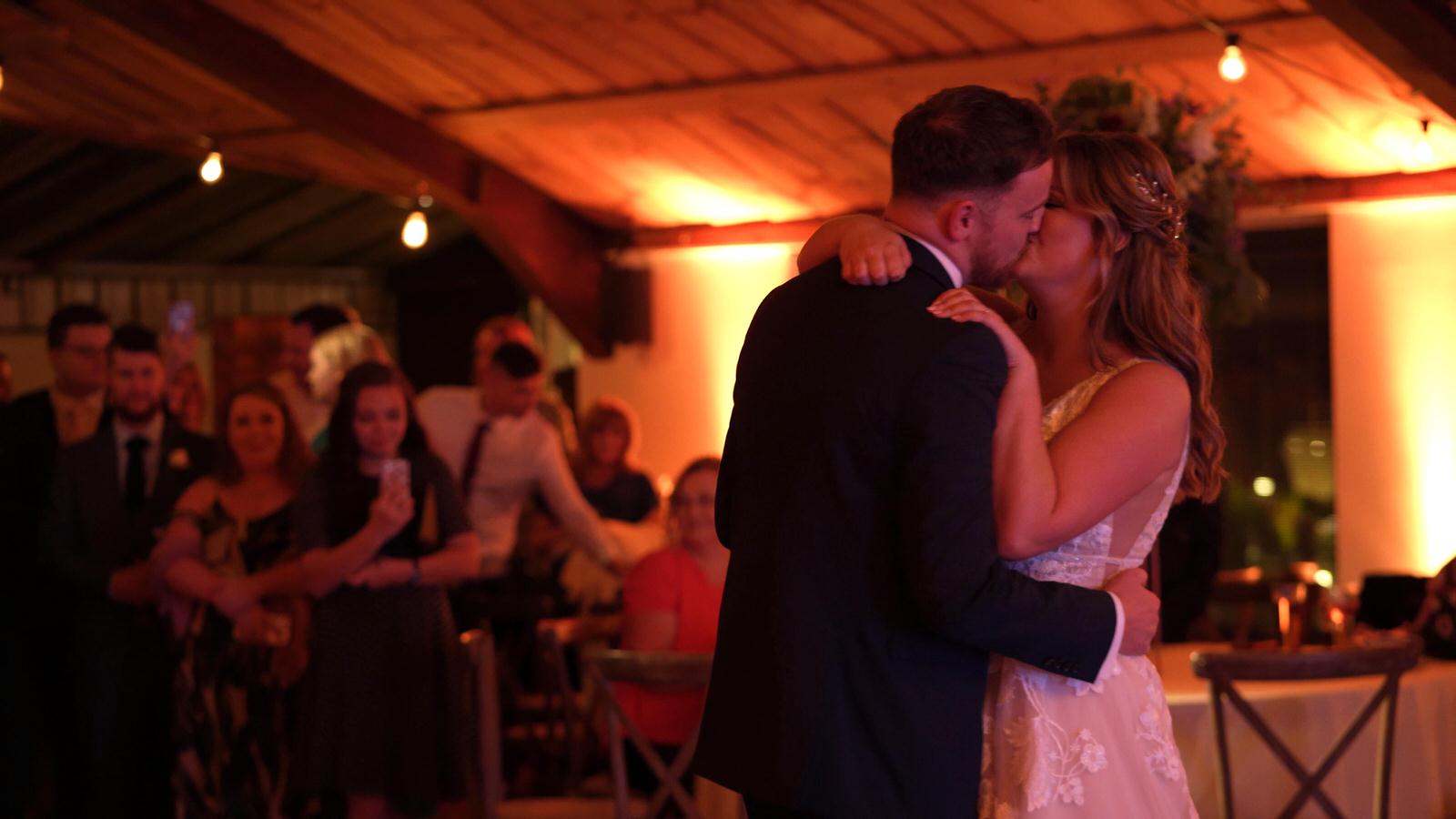 couple kiss during first dance at Owen House Barn