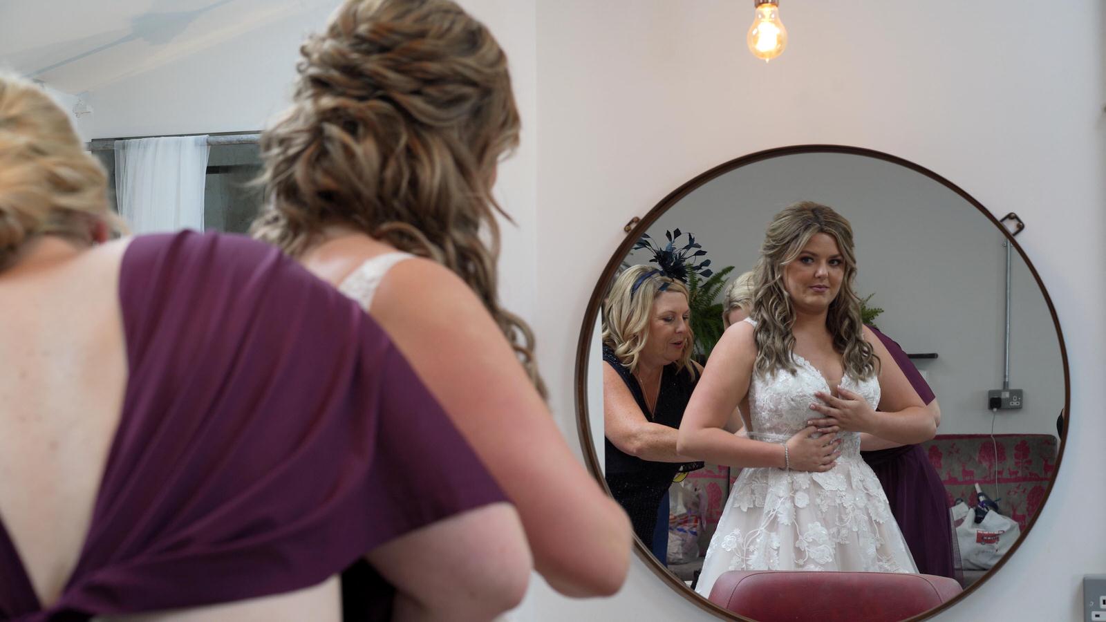 video still of bride seeing herself in a mirror at owen house
