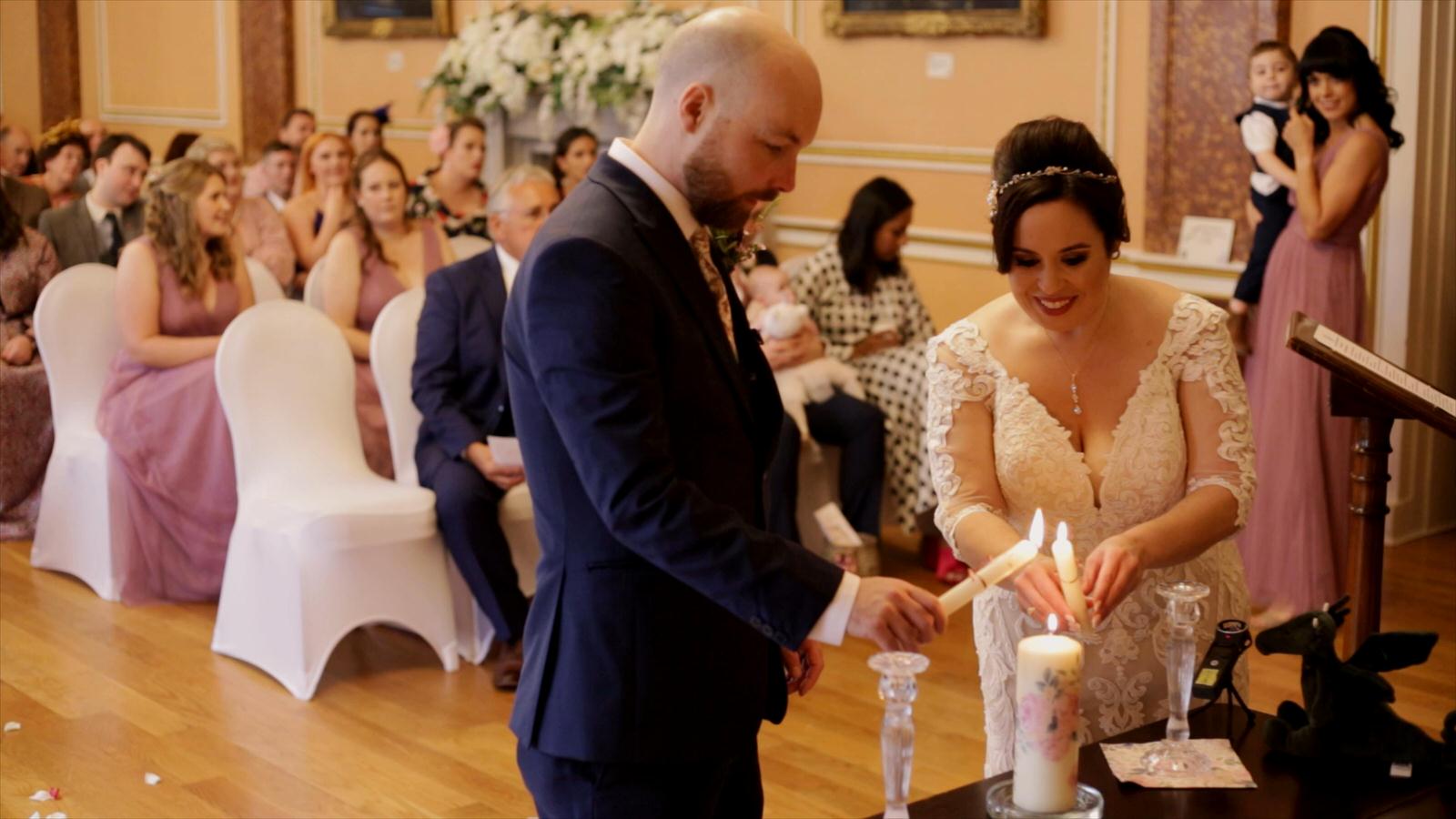 couple light a candle in memory of mum