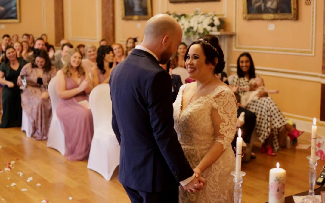 couple smile at each other during town hall wedding