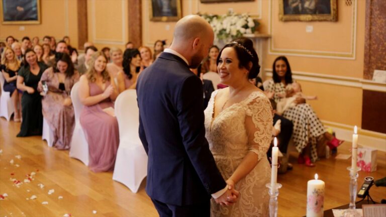 couple smile at each other during town hall wedding