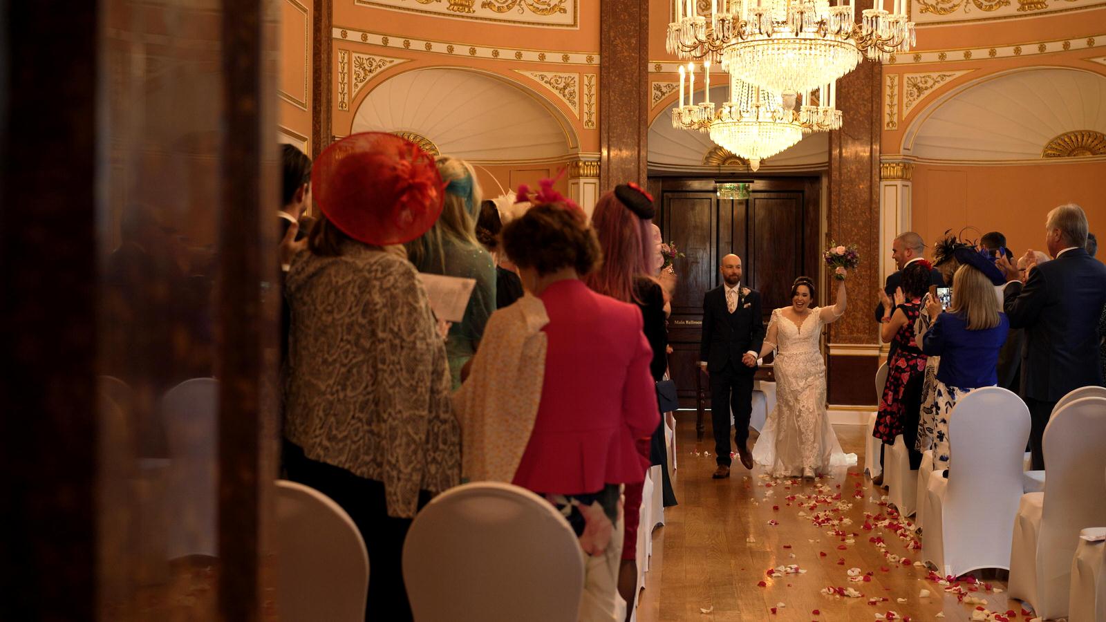 bride and groom walk down the aisle at liverpool town hall
