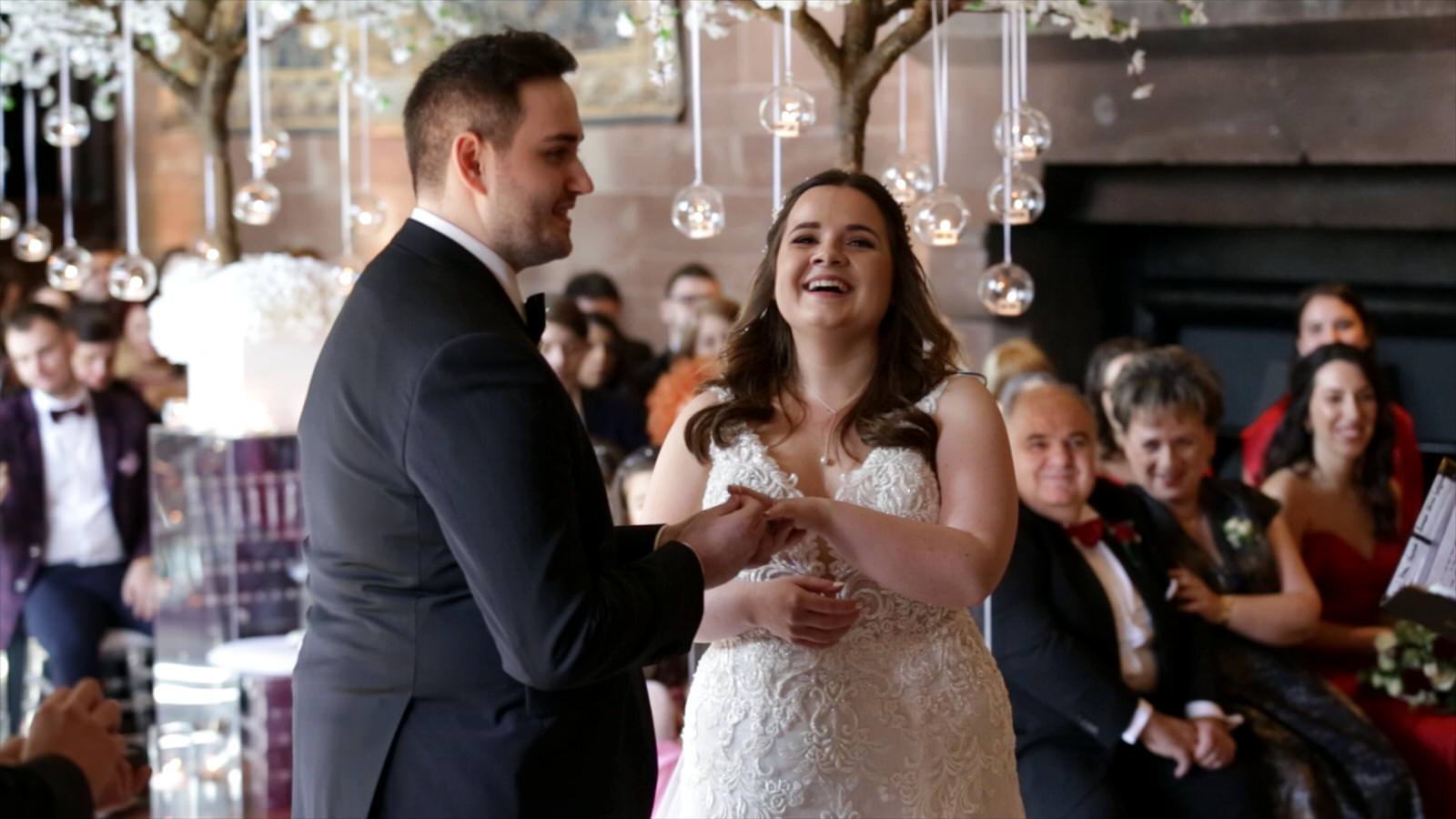 couple laugh during wedding ceremony in the great hall