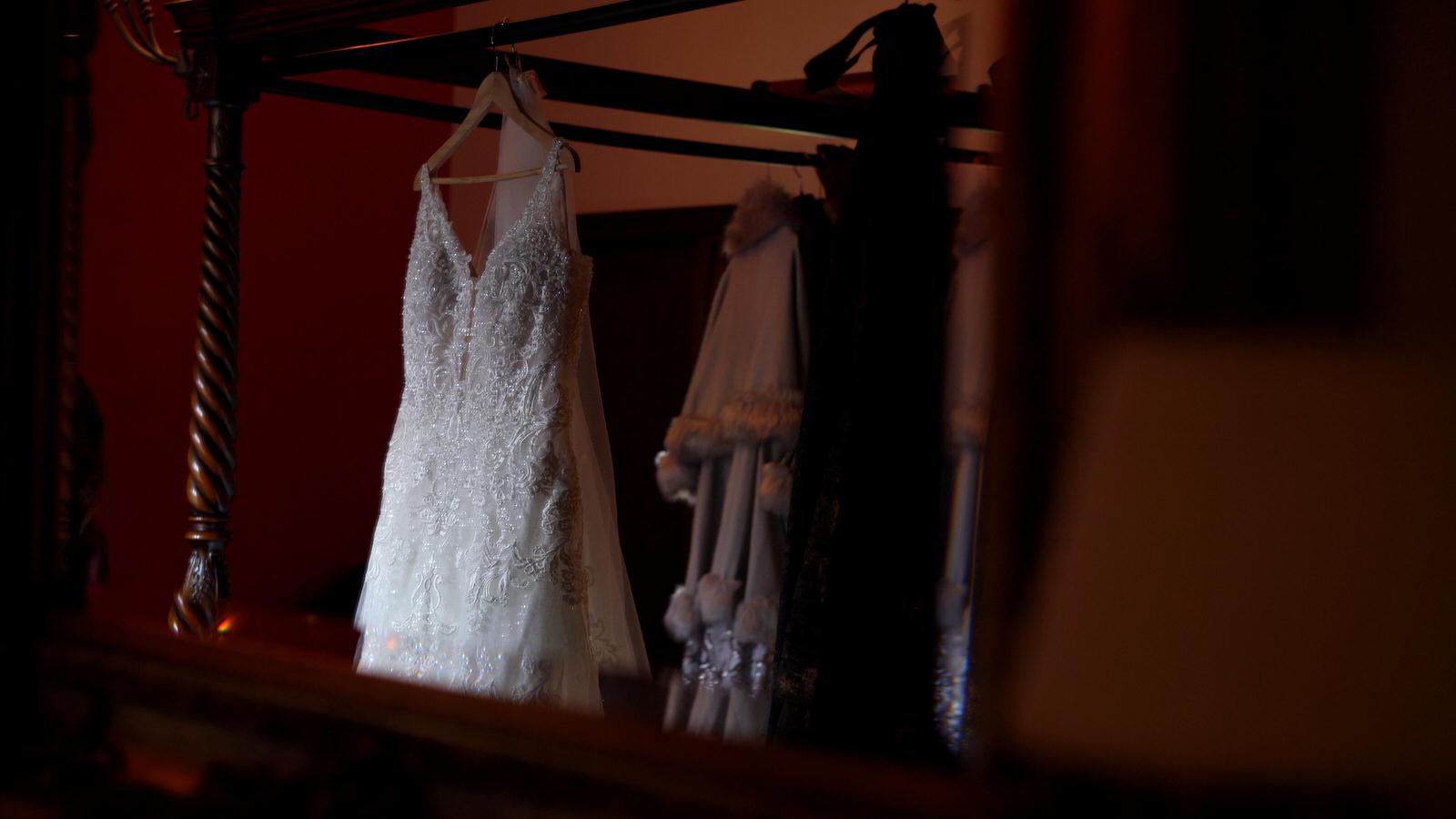 wedding dress hangs in peckforton castle suite