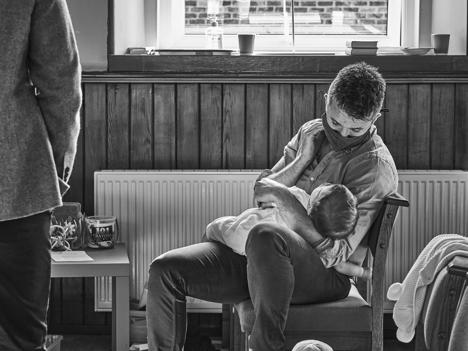 dad gazes at sleeping baby after christening