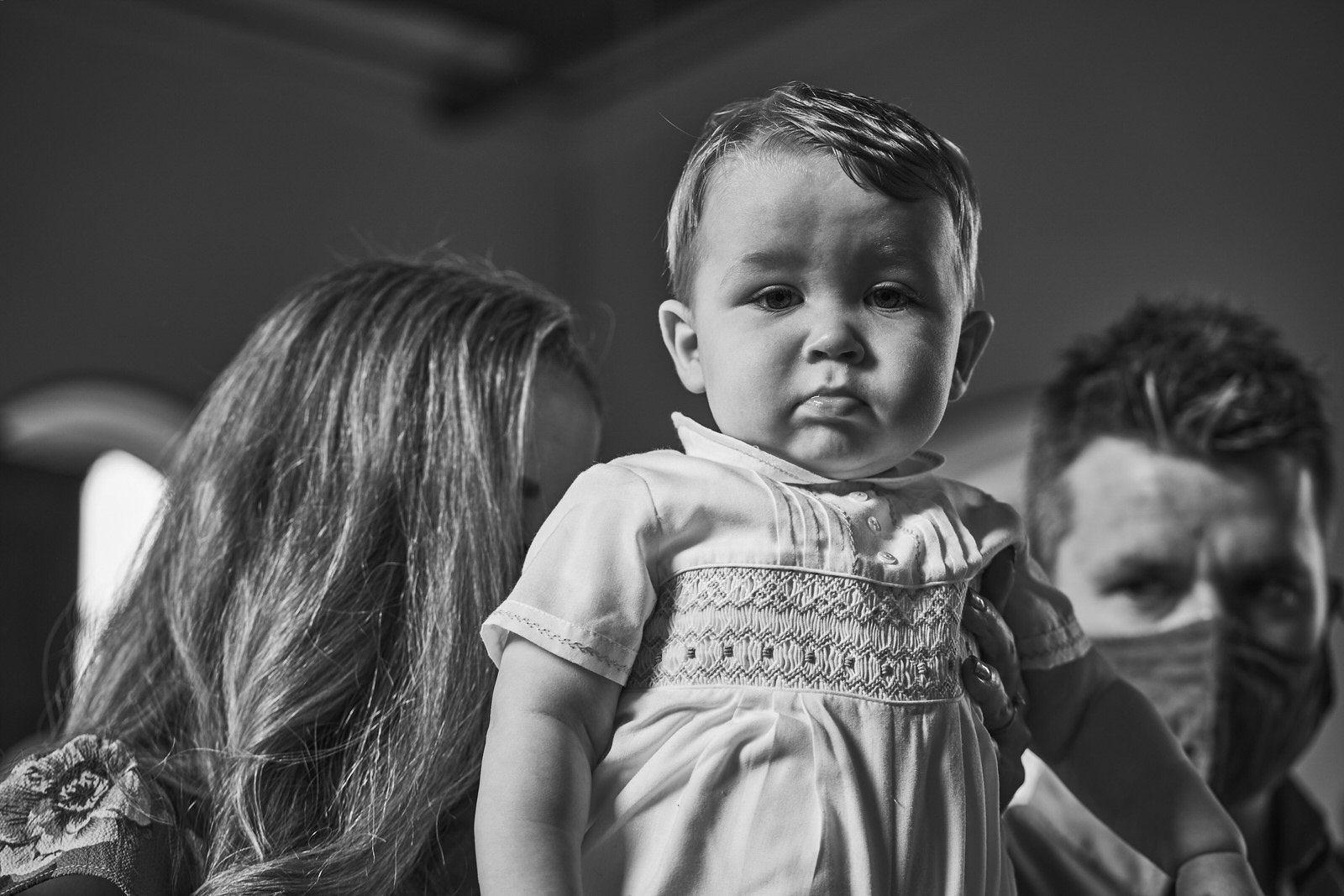 baby looks at photographer during church service