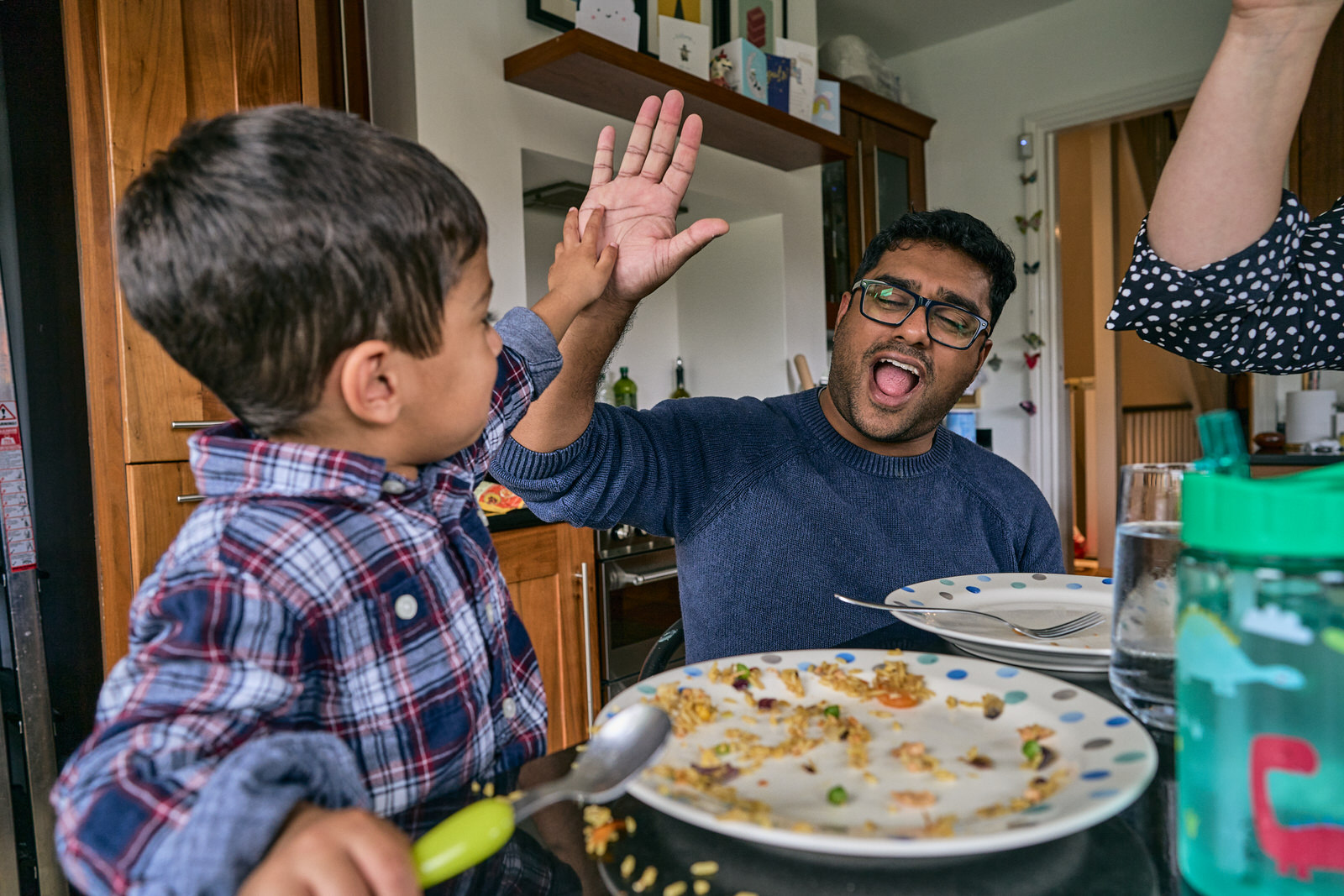 dad high fives son for eating his lunch