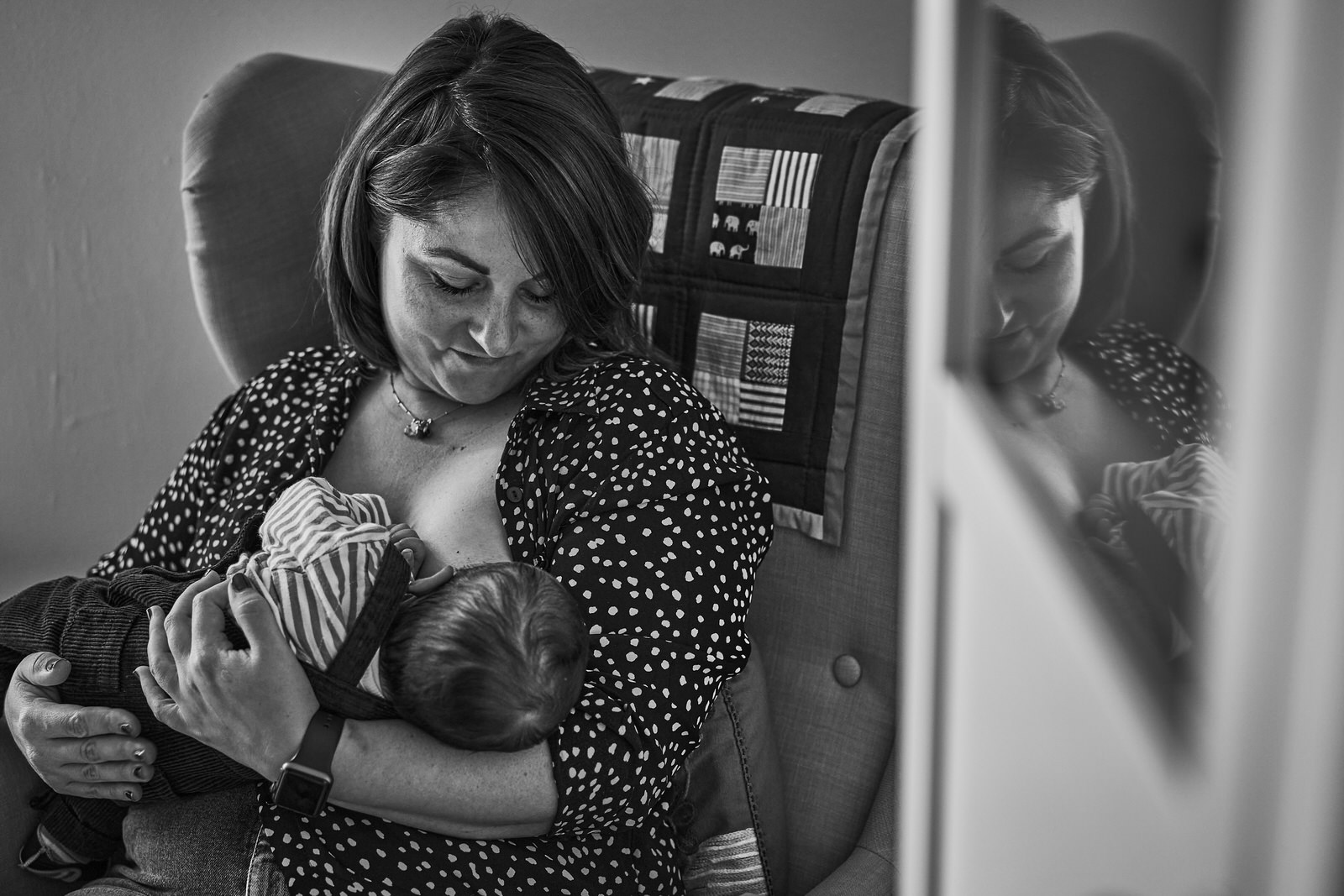 mum gazes at newborn baby as she breastfeeds