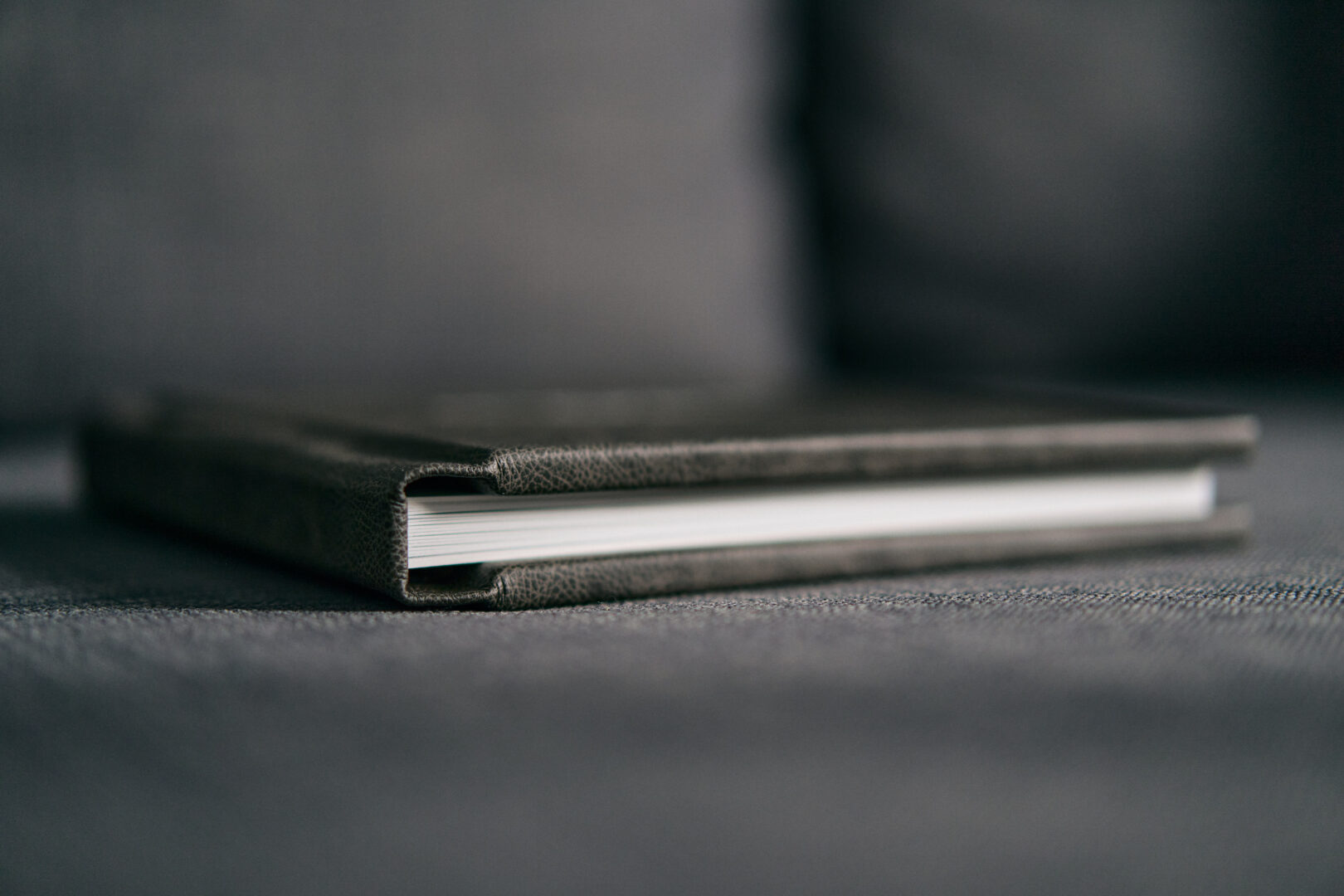 photo album closed on grey sofa in family home