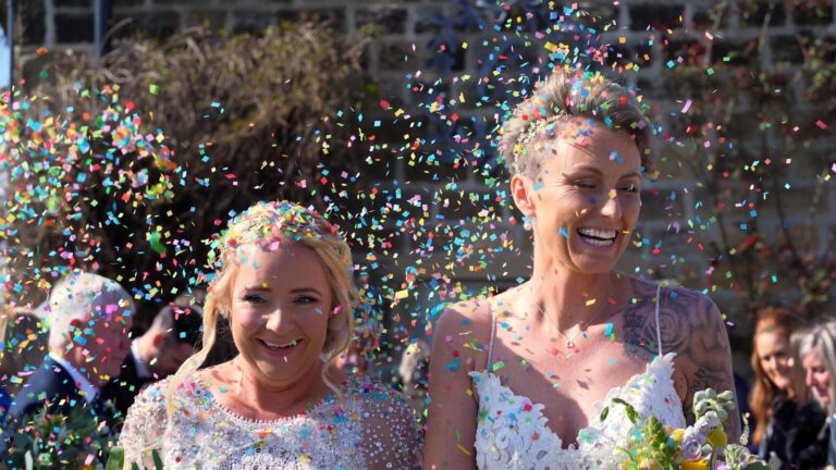 close up video still of brides and rainbow confetti