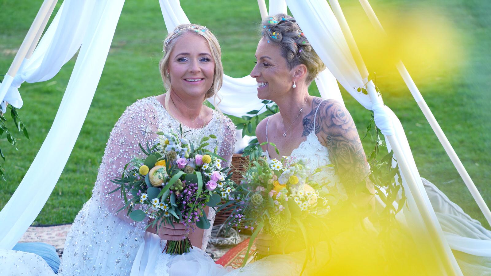 bride looks lovingly at her new wife