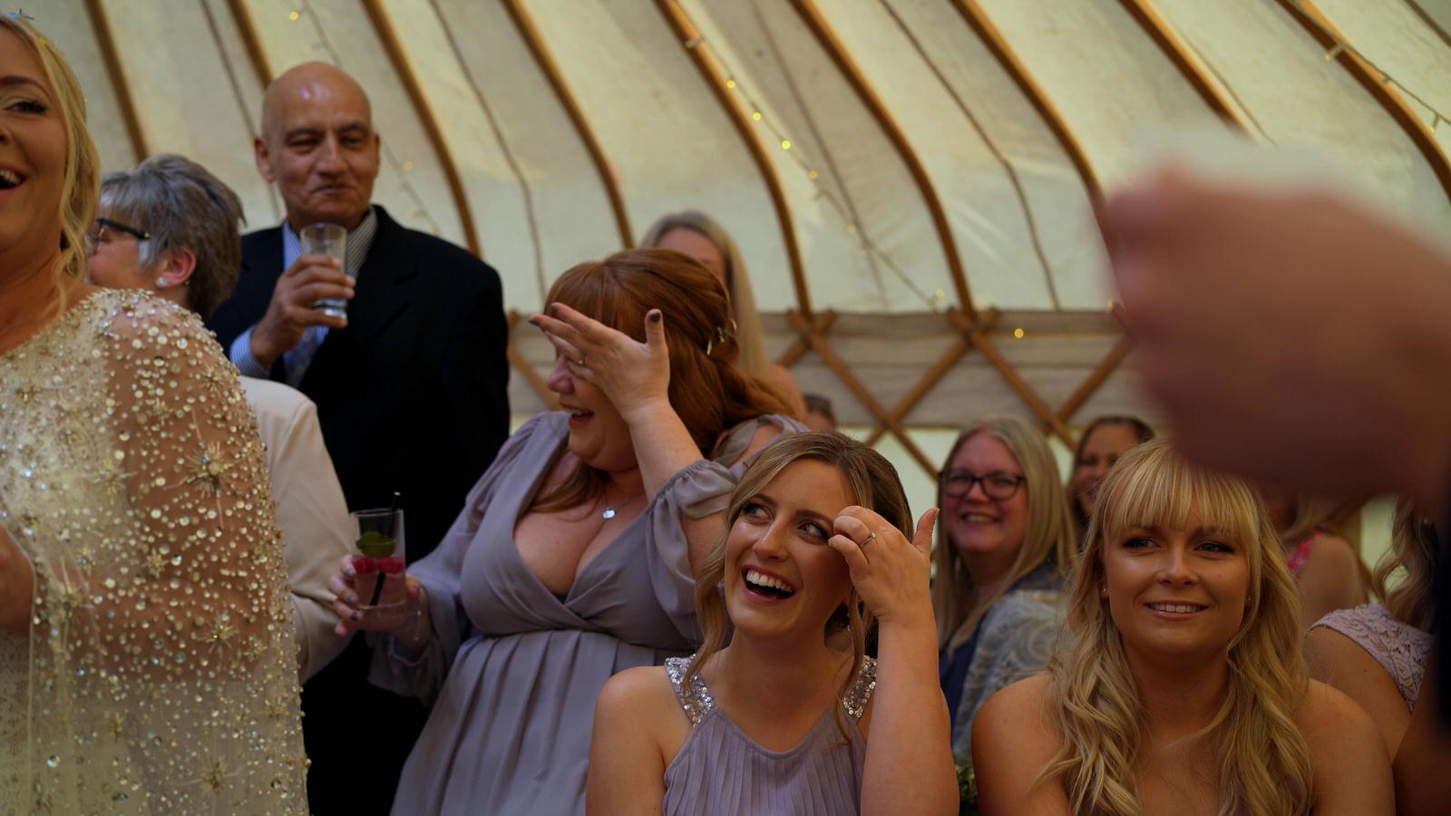 guests laugh and wipe away tears during speeches