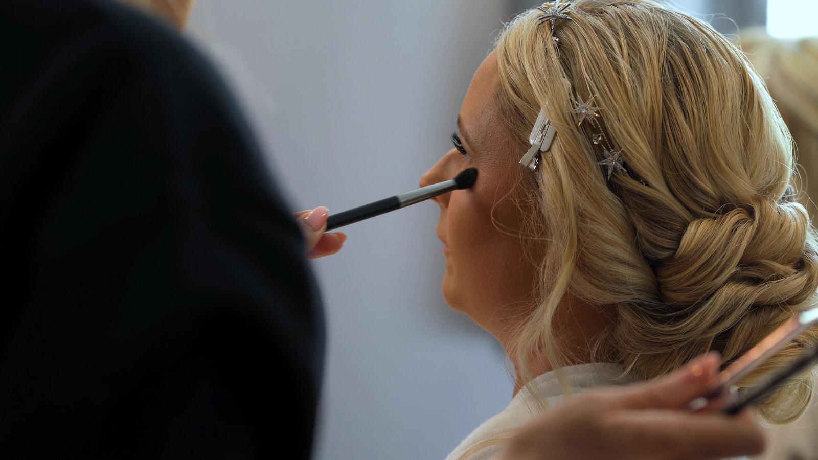 bride getting makeup touched up