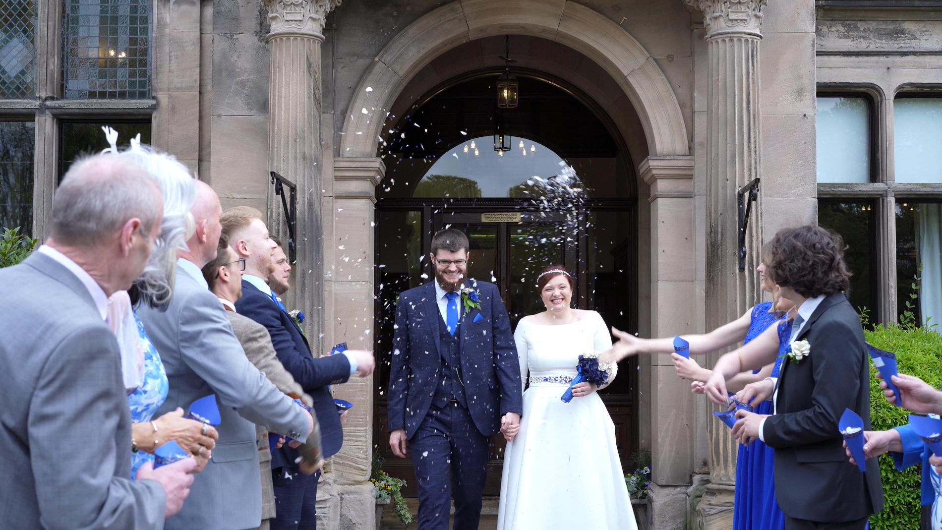 couple outside Rookery Hall for confetti photo and video