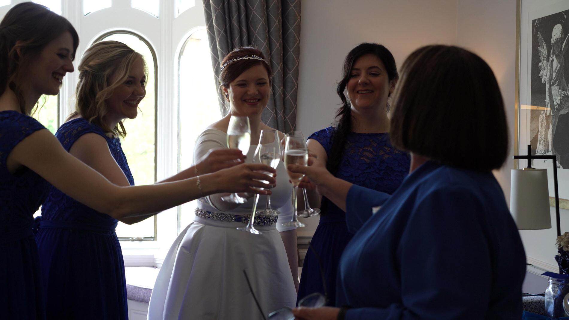 bridal party say cheers at Rookery Hall