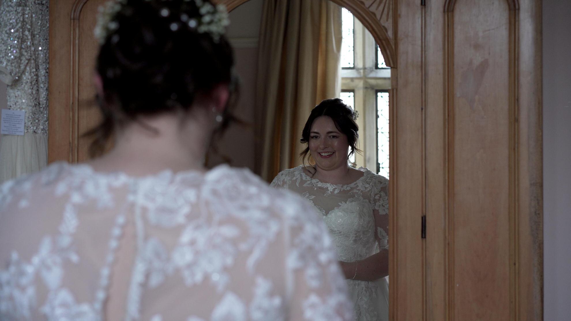 bride looks at her reflection in the bridal suite at Wyresdale Park