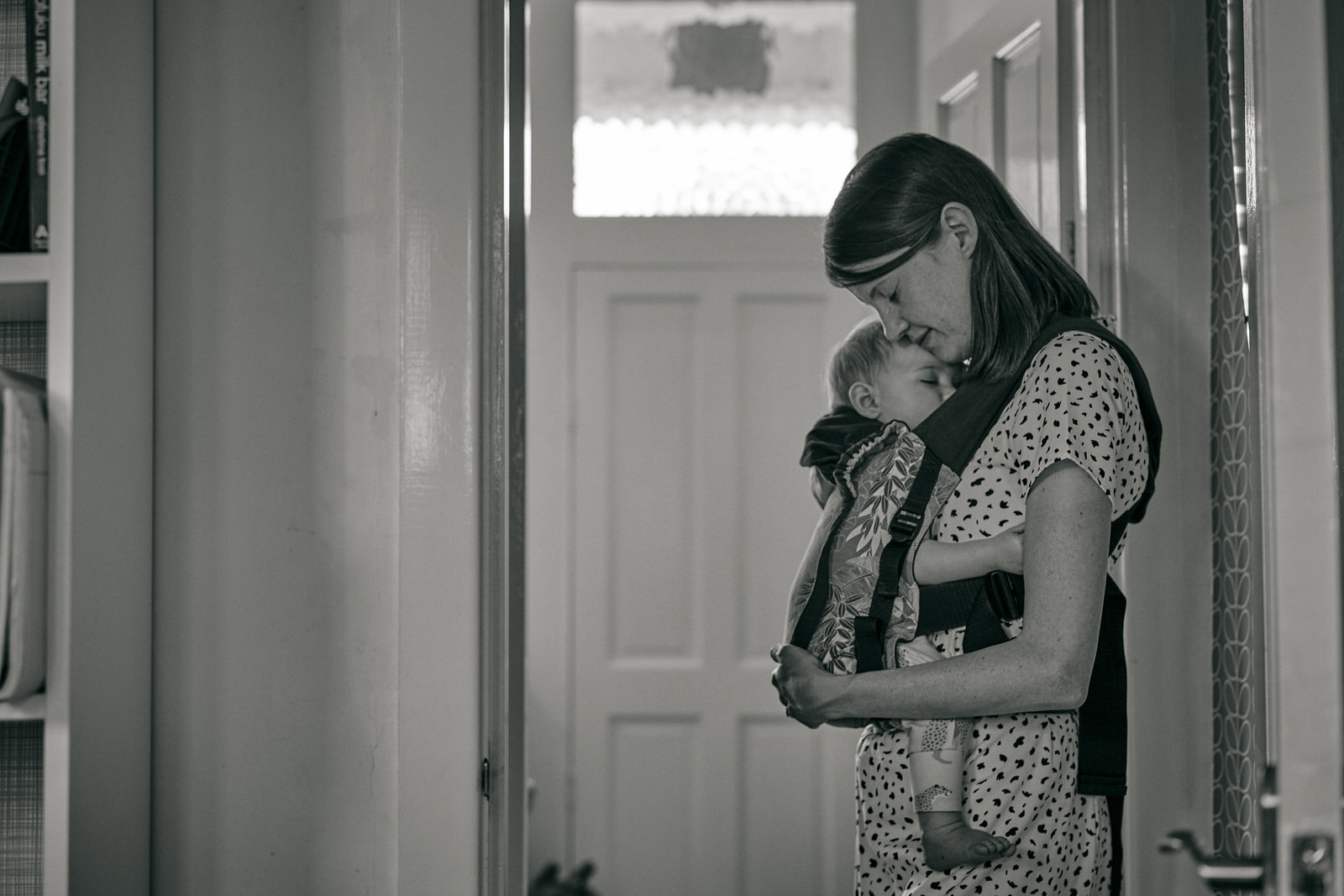 mum cuddles baby in her sling