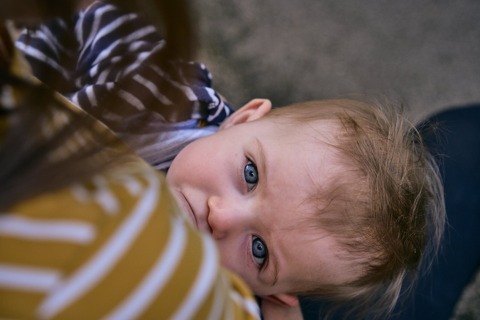 breastfeeding baby looks at the camera