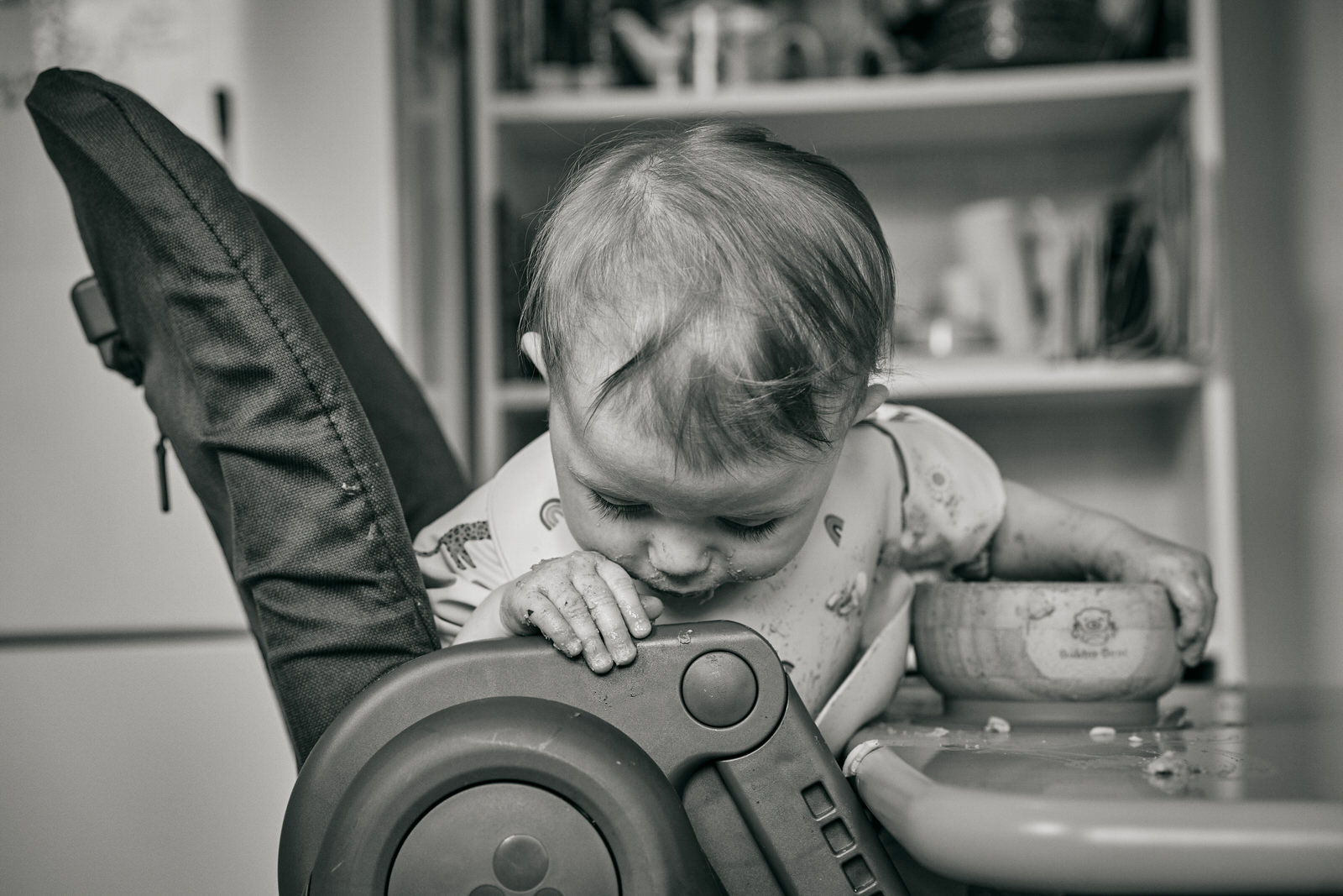 baby looks for food dropped on the floor