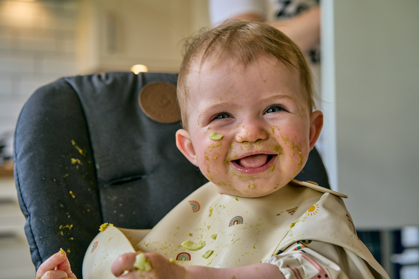 candid photo of toddler smiling at photographer