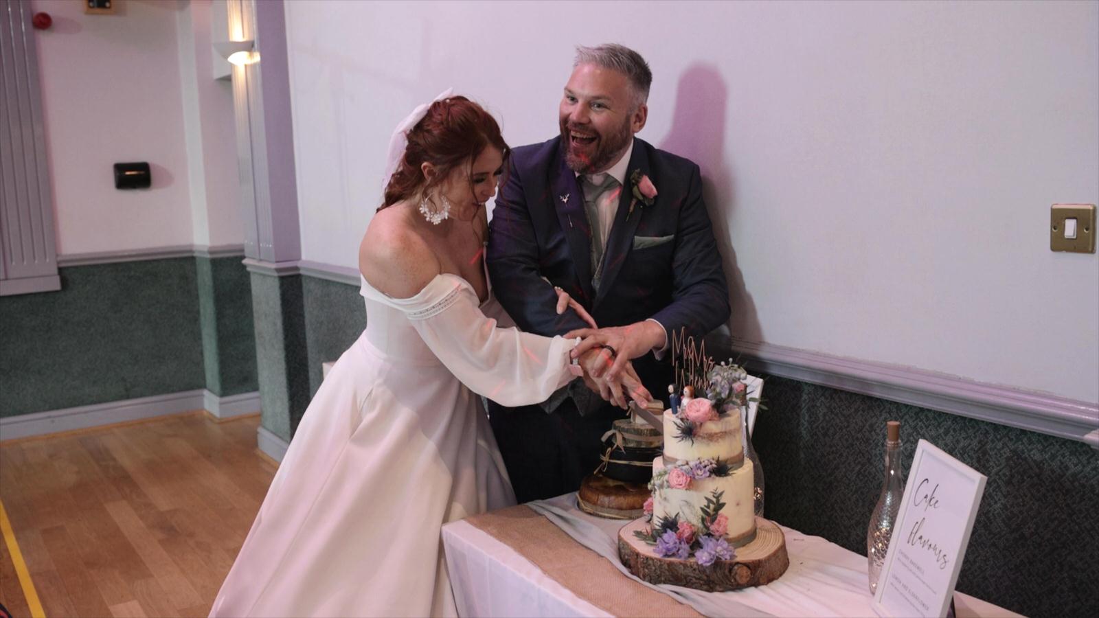 bride and groom cut their wedding cake
