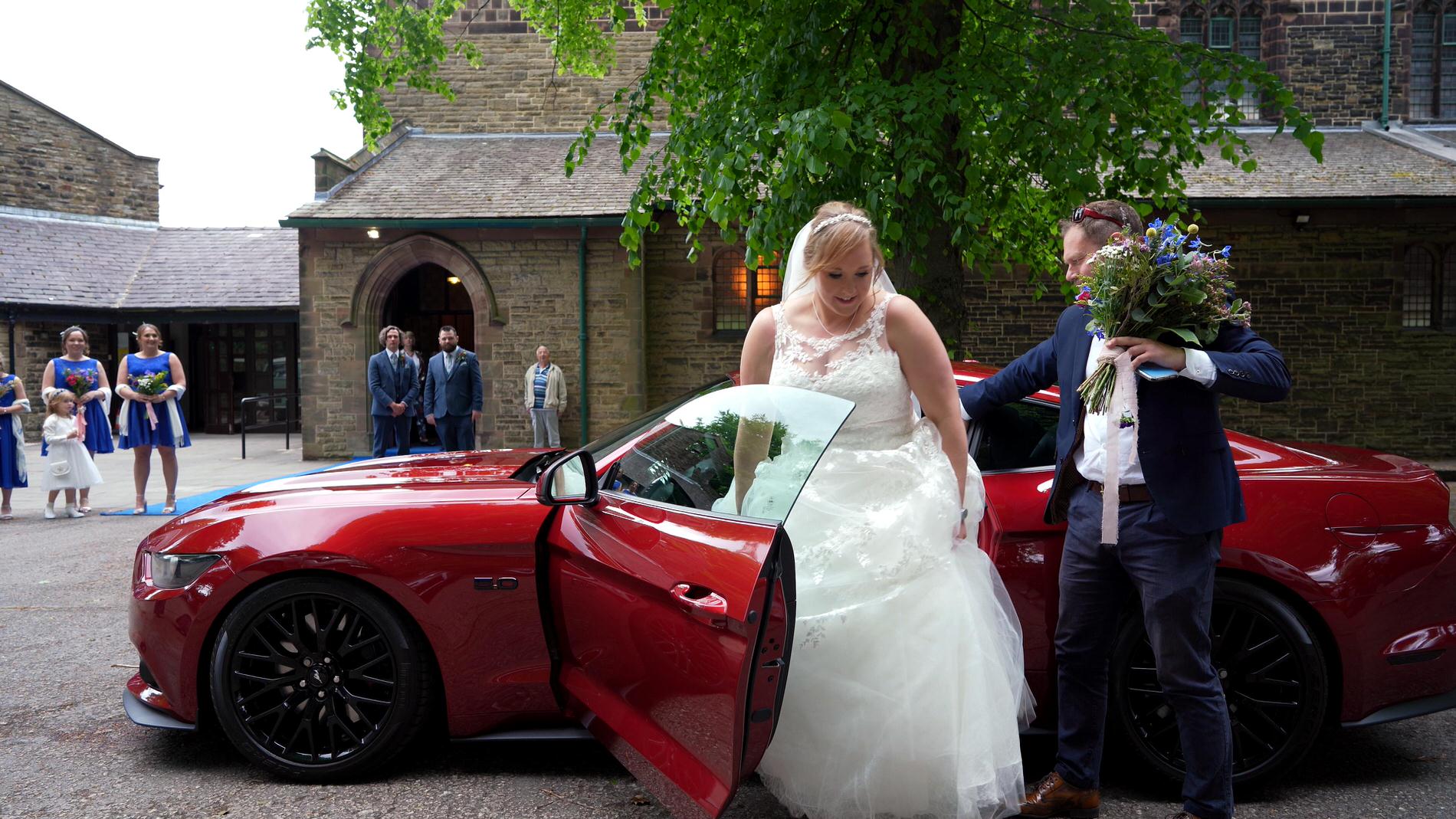 bride steps out of Shabang Ford Mustang wedding car