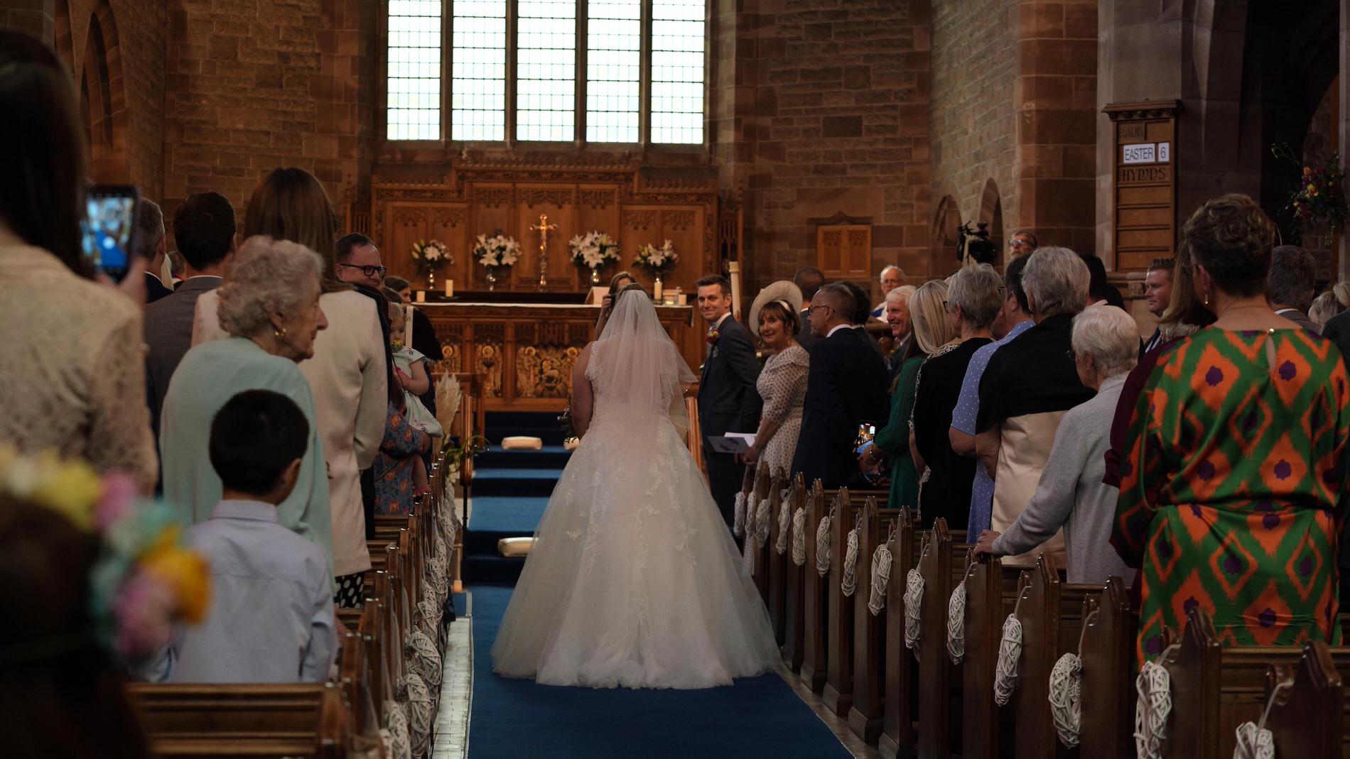 bride walks down aisle at Orrell Church