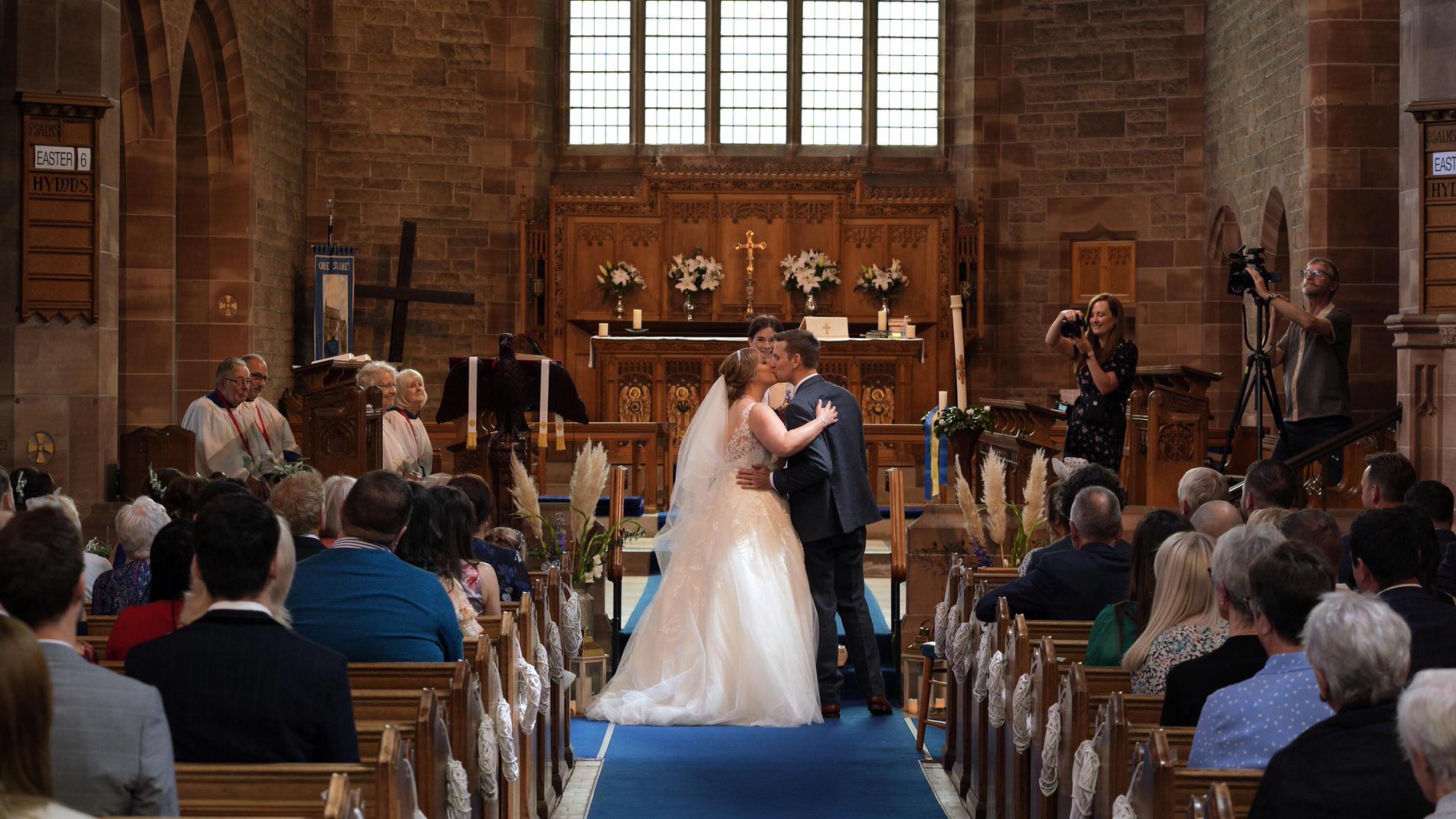 video still of kiss during ceremony at St Lukes Orrell