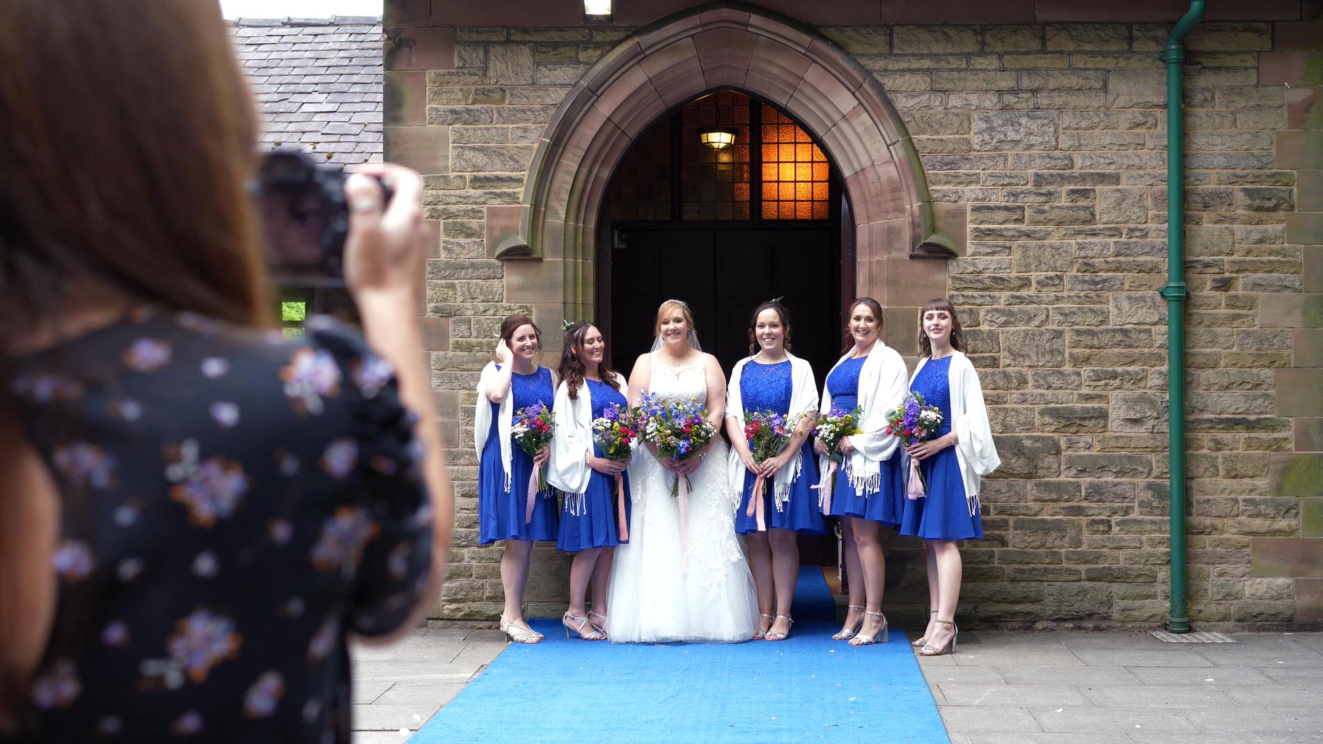 video still of Emma Billsborough taking group photos