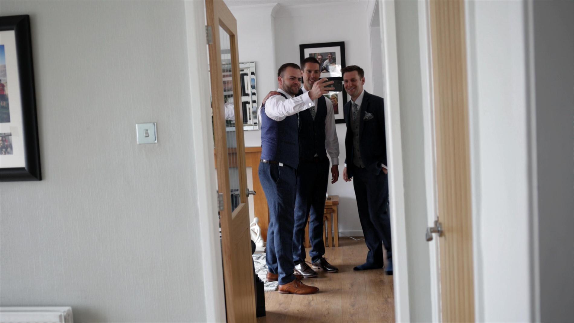 groom poses for a selfie