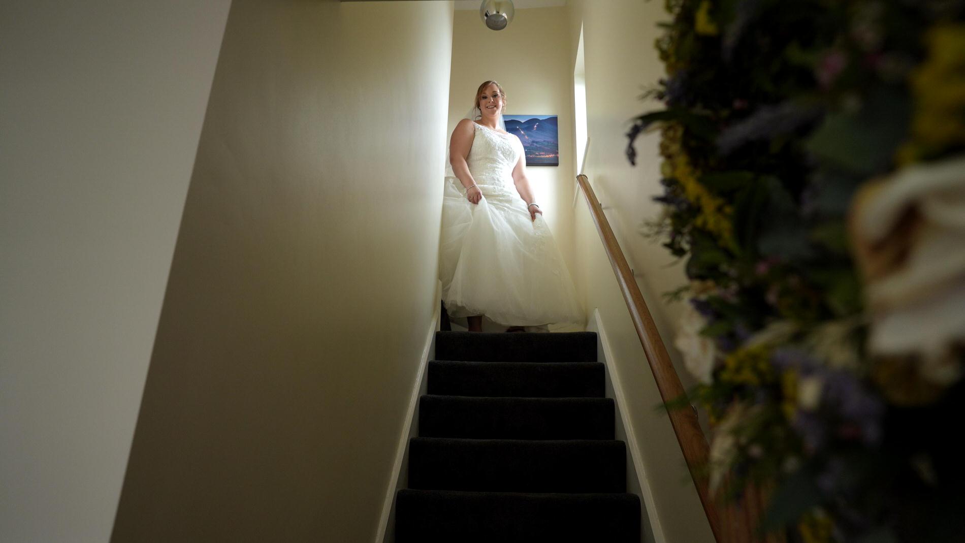 bride starts to walk down the stairs