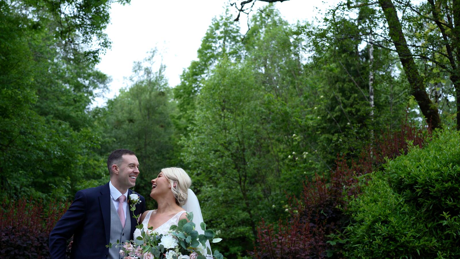 couple laugh with videographer in Rivington hall barn gardens