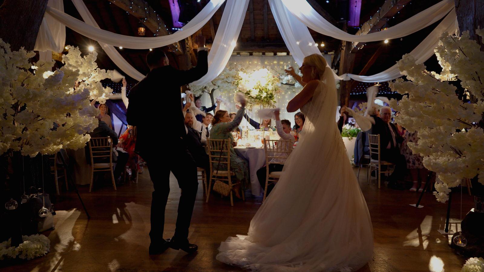 couple dance in to stylish wedding reception at Rivington hall barn