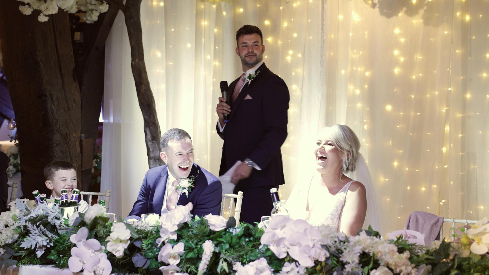 couple laugh during best mans speech