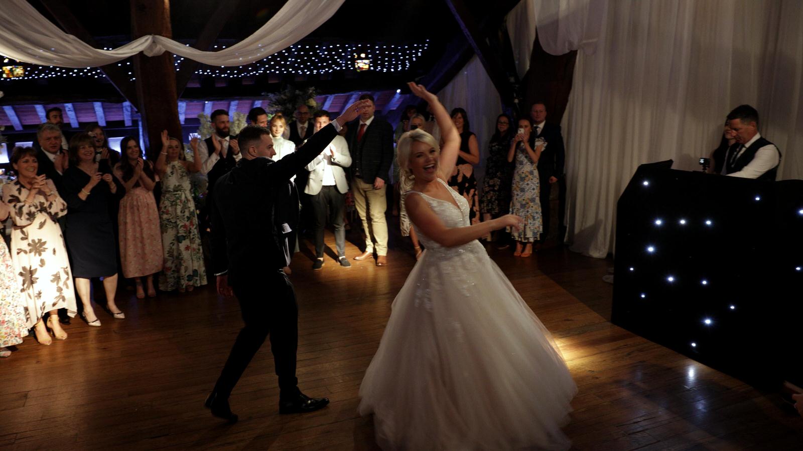 bride spins during first dance at Rivington hall barn