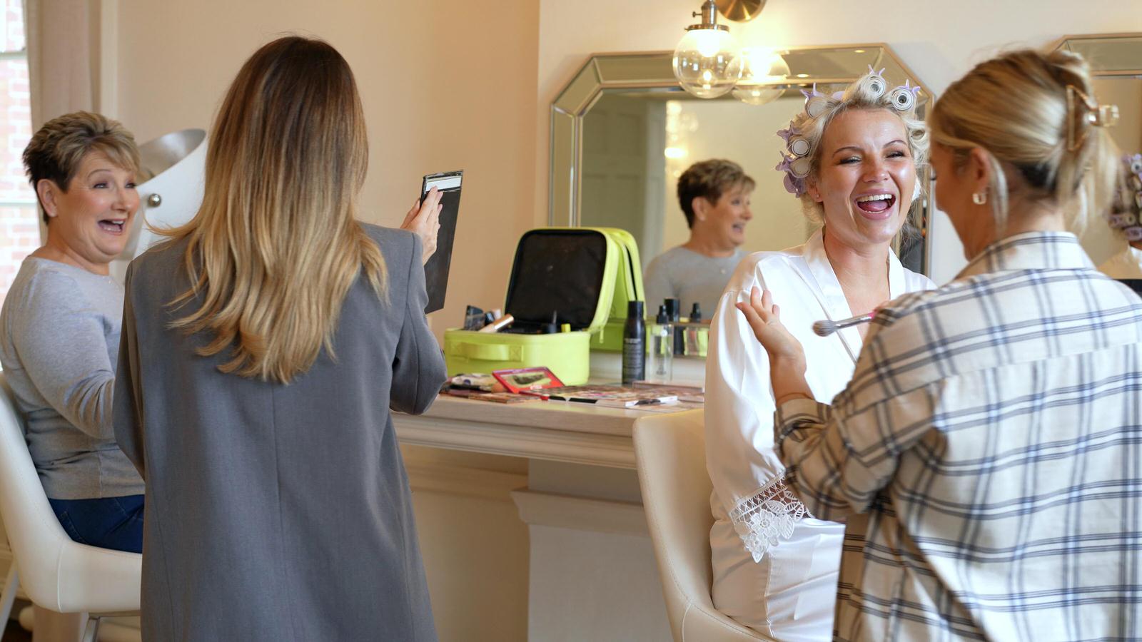 bride and mum have makeup done at Rivington hall barn