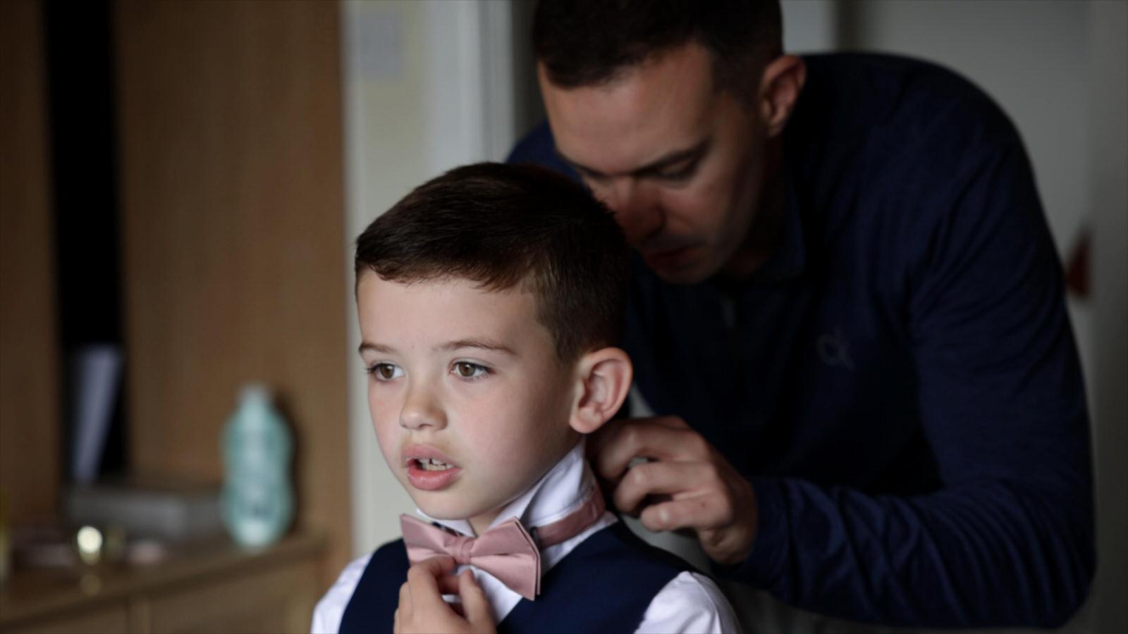 dad fixes sons bow tie on wedding morning in lancashire